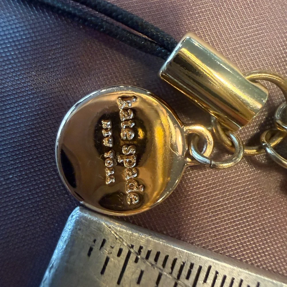 kate spade Gold Tone Phone Wrist Strap with Black Cord Loop